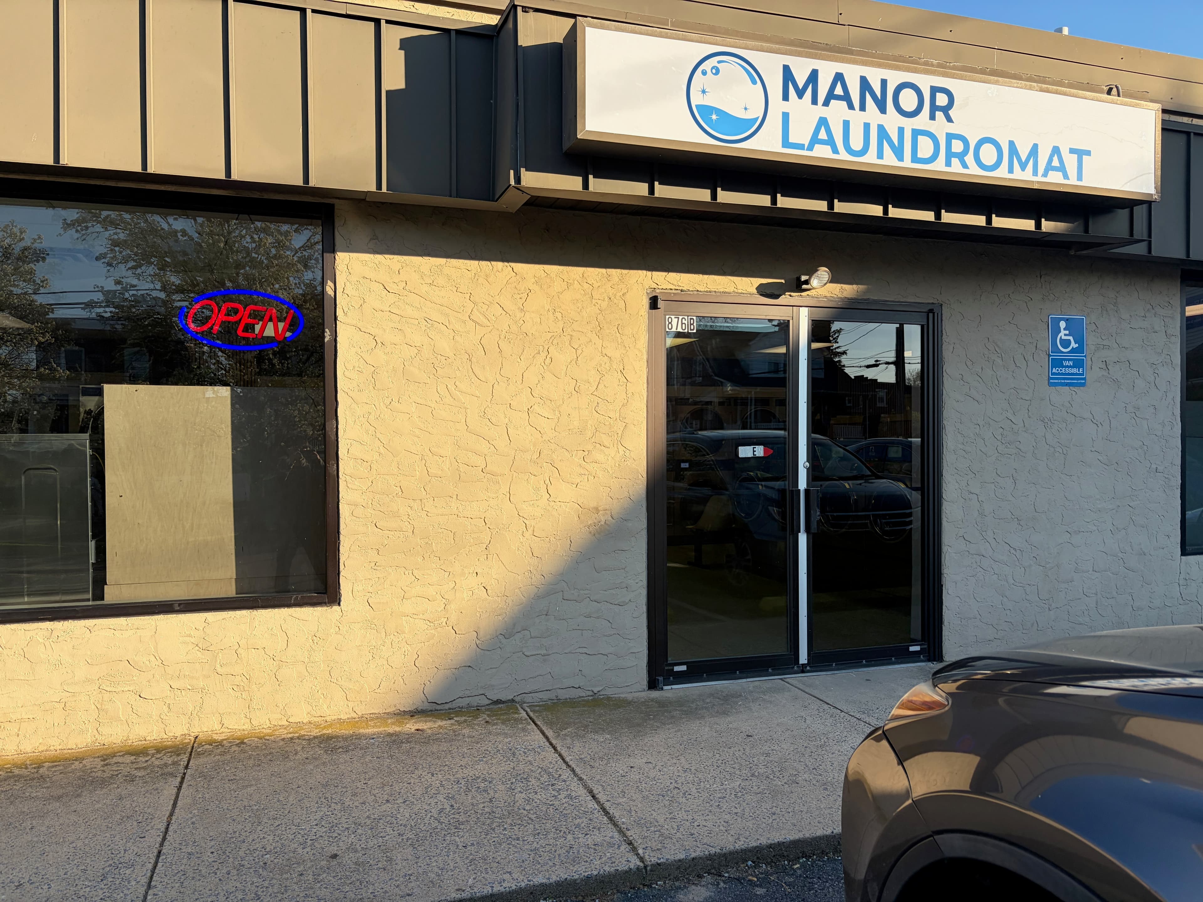 Exterior storefront of Manor Laundromat at 876 Manor Street, Lancaster PA with open sign
